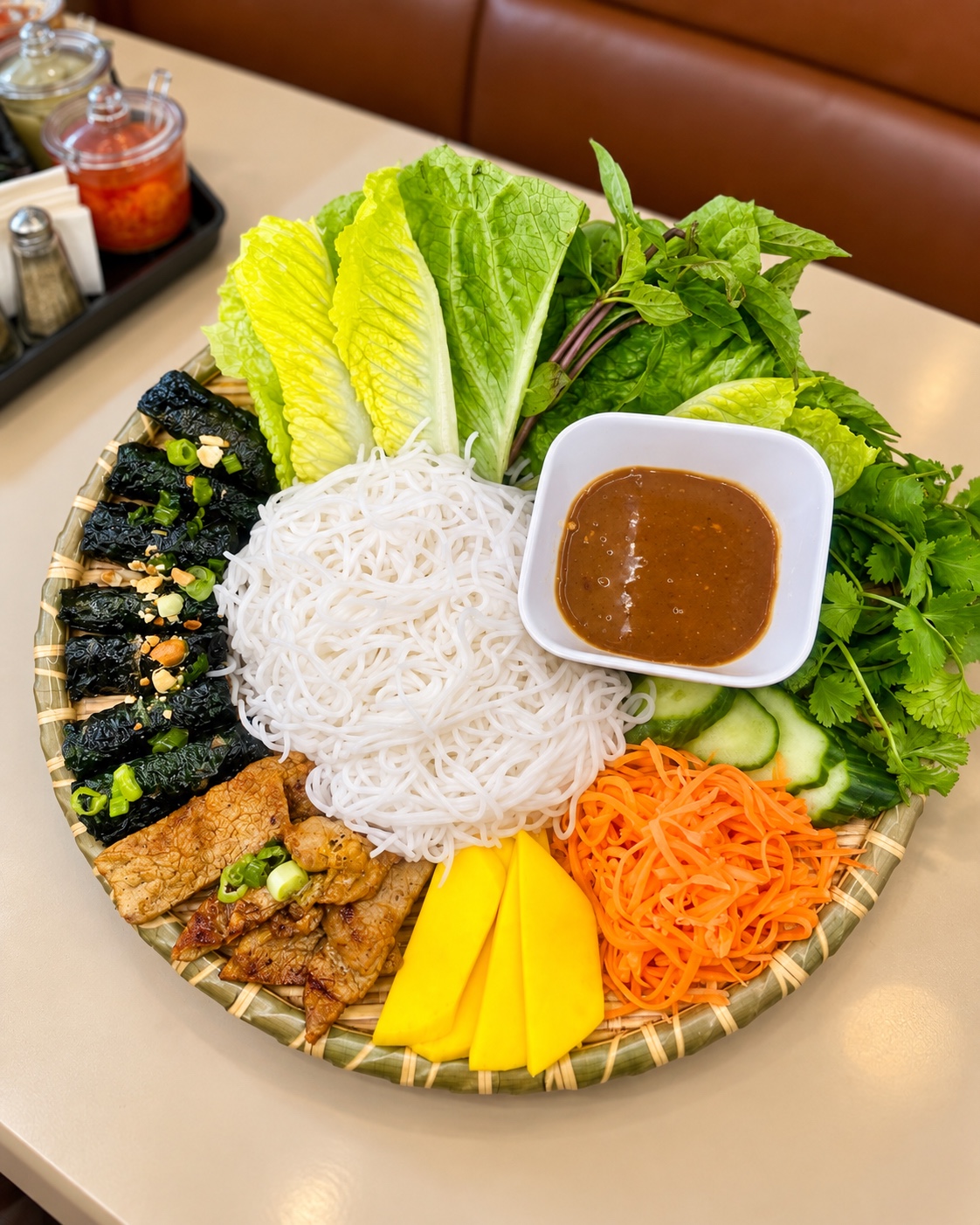 Vietnamese vermicelli platter with grilled meats, herbs and sauce