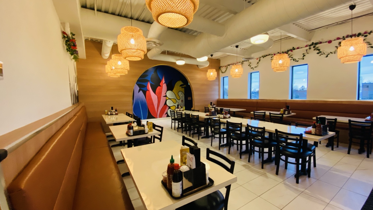 Pho Queen dining room with warm lighting and colourful mural